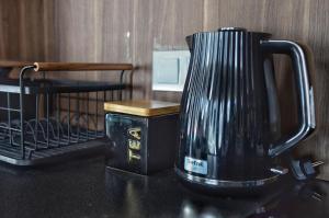 a black coffee maker sitting on a counter at Villa Corleone in Kąty Wrocławskie
