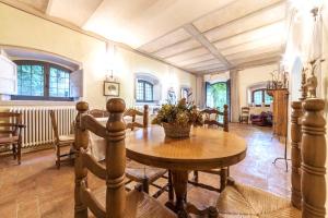 a dining room with a wooden table and chairs at antica Villa con Giardino in Bomarzo