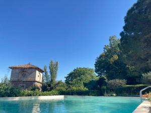 a swimming pool with a building in the background at antica Villa con Giardino in Bomarzo +96 photos