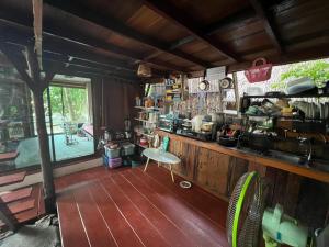 a kitchen with a counter and a chair in a room at Smiley Bungalows Guesthouse in Srithanu