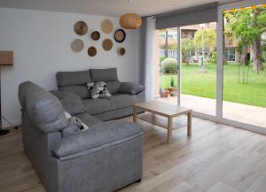 a living room with a couch and a table at Jamaica Beach House in Puebla de Farnals