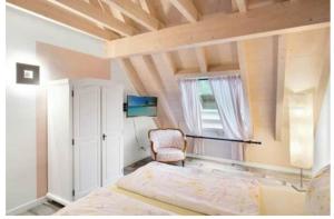 a bedroom with a bed and a chair at Landhaus am Schloss in Küps