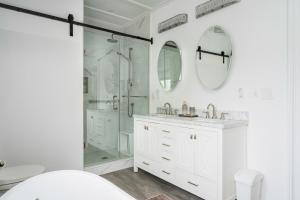 a white bathroom with a shower and a sink at 3bed 2bath heritage duplex - Prime Location in Collingwood +29 photos