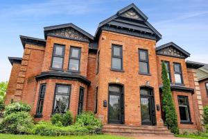 a red brick house with a black roof at 3bed 2bath heritage duplex - Prime Location in Collingwood