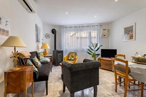 a living room with a couch and a table at L'Oreneta, Le Boulou, idéal curiste in Le Boulou