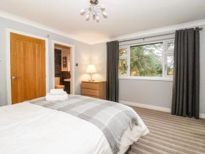 a bedroom with a bed and a window at The Pines in Skipton