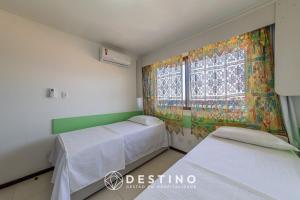a hospital room with two beds and a window at Apto Vista/Beira-Mar, Pé na Areia - Destino BSM 214 in Barra de São Miguel +71 photos