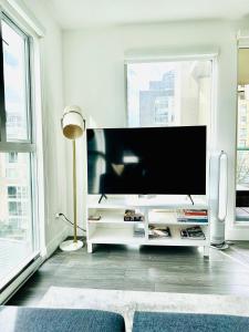 a living room with a large flat screen tv at Luxury condo beach side Yaletown in Vancouver