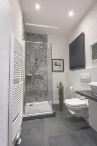 a bathroom with a shower and a toilet and a sink at Fewo Adam und Eva in Bamberg +12 photos
