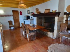 una sala da pranzo con tavolo e camino di Gîtes de Charme Lalaurie a Sauveterre-la-Lémance