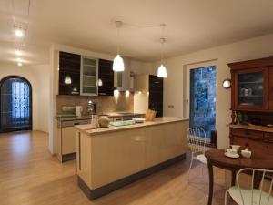 a kitchen with a counter and a table in a room at Appartement Györi. in Millstatt