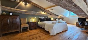 a bedroom with a bed and a wooden floor at Château la bastide cardan in Saint-Sulpice-de-Pommiers +52 photos