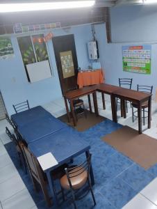 a room with tables and chairs and a table at Hostel MariaJose in Baños +39 photos