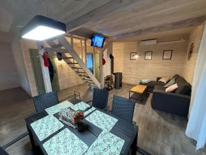 a living room with a table and a couch at Domki pod Aniołem in Huta