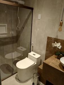 a bathroom with a shower and a toilet and a sink at Casa Portal do Sol JP in João Pessoa +13 photos
