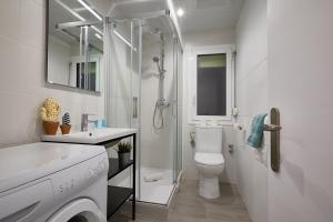 a bathroom with a shower and a toilet and a sink at BBarcelona Gracia Apartment in Barcelona +18 photos