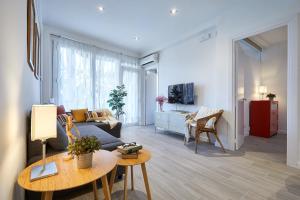 a living room with a couch and a table at BBarcelona Gracia Apartment in Barcelona