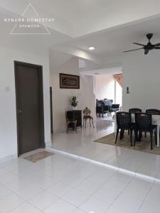 a living room with black chairs and a table at Rynurr Homestay A Famosa near Waterpark in Kampong Pulau Sebang