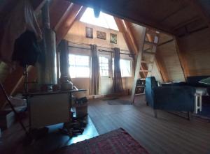 a living room with a couch and a ladder in a house at Casa Alpina Puerto Varas in Puerto Varas