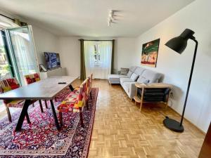 a living room with a couch and a table at Chalet mit Pool & Sauna in Ehrenhausen