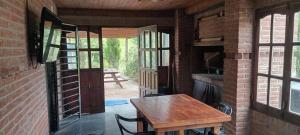 a room with a wooden table and a brick wall at Casa quinta vacacional in Mar del Tuyú
