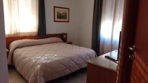 Postel nebo postele na pokoji v ubytování GH Hotel
