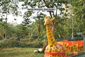 a toy giraffe in the middle of a park at Hotel O Gems in Turambhe