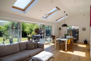 a living room with a couch and a table at Gorgeous home for 12 - Walk to Beach - Sea View in Chichester