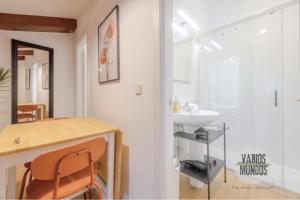 a bathroom with a sink and a table with a chair at Fashion Design Loft en Calle Carretas-Sol para 4pax in Madrid +23 photos