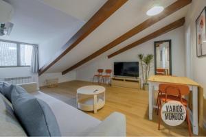 a living room with a couch and a table at Fashion Design Loft en Calle Carretas-Sol para 4pax in Madrid