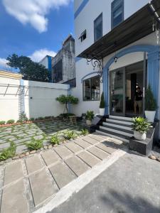 a house with a stone walkway in front at The Sun Hotel in Long Bình