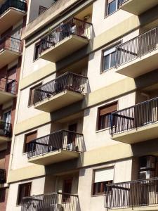 a facade of an apartment building with balconies at Mimì Rooms in Cagliari