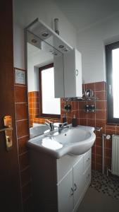 a bathroom with two sinks and a mirror at Hotel Resi Beverungen in Beverungen +13 photos