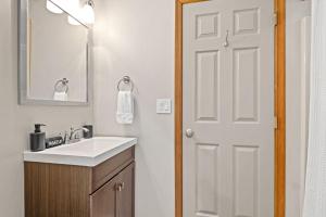 a bathroom with a sink and a white door at Love Lace Retreat in Albrightsville +38 photos