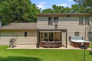 a house with a hot tub on a patio at Love Lace Retreat in Albrightsville