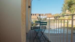 a porch with two chairs on a balcony at Superbe appartement entier et traversant 135m2, classé 5 étoiles, Sarlat centre in Sarlat-la-Canéda