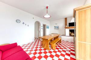 a living room with a red couch and a table at Le Carrube Vista Mare in Andrano