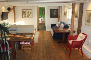 a living room with a table and a couch at Bessie May Cottage in Beaulieu +56 photos