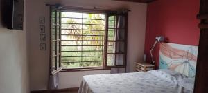 a bedroom with a bed and a large window at Casa quinta vacacional in Mar del Tuyú