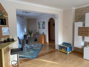 a living room with a kitchen and a desk at Apartment Katharina in Klagenfurt