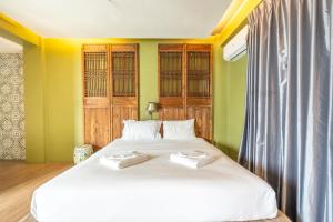 a bedroom with a bed with two towels on it at See Sea Villa Phuket SHA in Patong Beach +105 photos