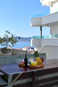 a picnic table with a plate of food and a bottle of wine at Vila Maričić in Sveti Petar