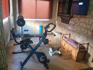 a room with two exercise bikes and a bed at RURAL EL SANTISCAL in Arcos de la Frontera