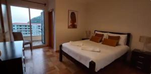 a bedroom with a large bed and a large window at Cozy apartment in Madeira Island in Ribeira Brava