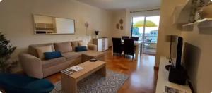 a living room with a couch and a table at Cozy apartment in Madeira Island in Ribeira Brava
