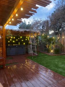 a patio with a wooden deck with a pergola at La balinaise in Évenos