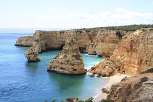 a view of a rock formation in the ocean at Casa Joaquina in Carvoeiro