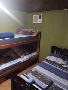 a room with two bunk beds and a fan at 7copas in Puerto Iguazú