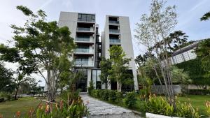 an apartment building with a garden in front of it at Patong Sea View pool view condo in Patong Beach