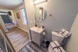 a bathroom with a sink and a toilet and a mirror at Oberlin Getaway in Oberlin +13 photos
